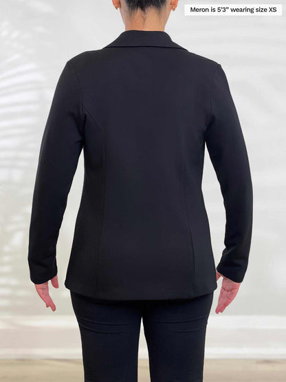 Miik model Meron (5’3”, xsmall) standing with her back towards the camera showing the back of Miik&