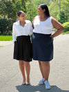 Miik models Meron and Sureka smiling while looking at each other both wearing Miik's Alara pocket swing skirt to show how is the fitting in different body types and size 