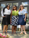 Miik models plus size Kimesha, Erica and Kelly all wearing Miik's Alara pocket swing skirt in different colour: black, white lily and navy