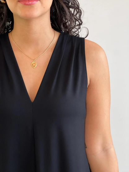 A close up shot of the neckline of the new Miik dress: Amberly sleeveless v-neck pocket dress in black 