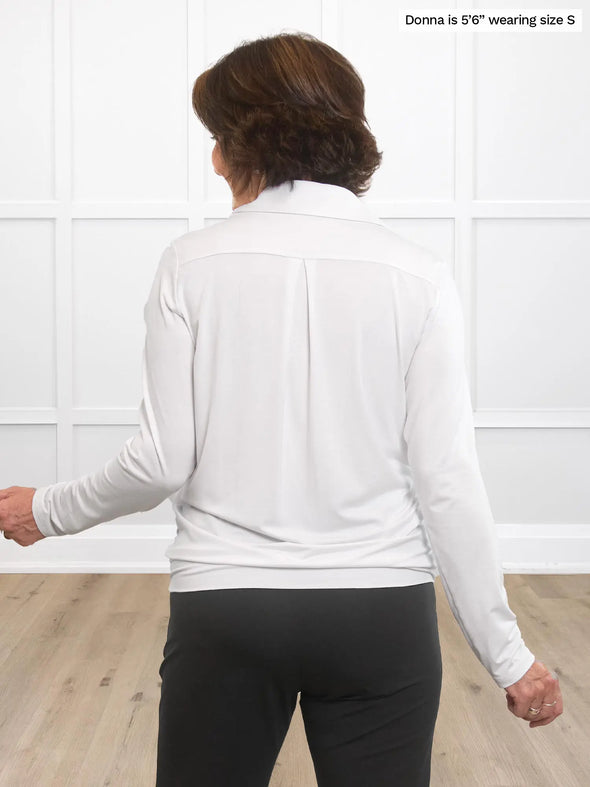 Miik founder Donna (5’6”, small) standing with her back towards the camera showing the back of Miik's Arianna collared shirt in white #color_white 