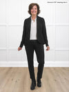 Miik founder Donna (5'6", small) smiling while standing in front of a white studio wall wearing a black suit - pants and blazer, along with Miik's Arianna collared shirt in white
#color_white