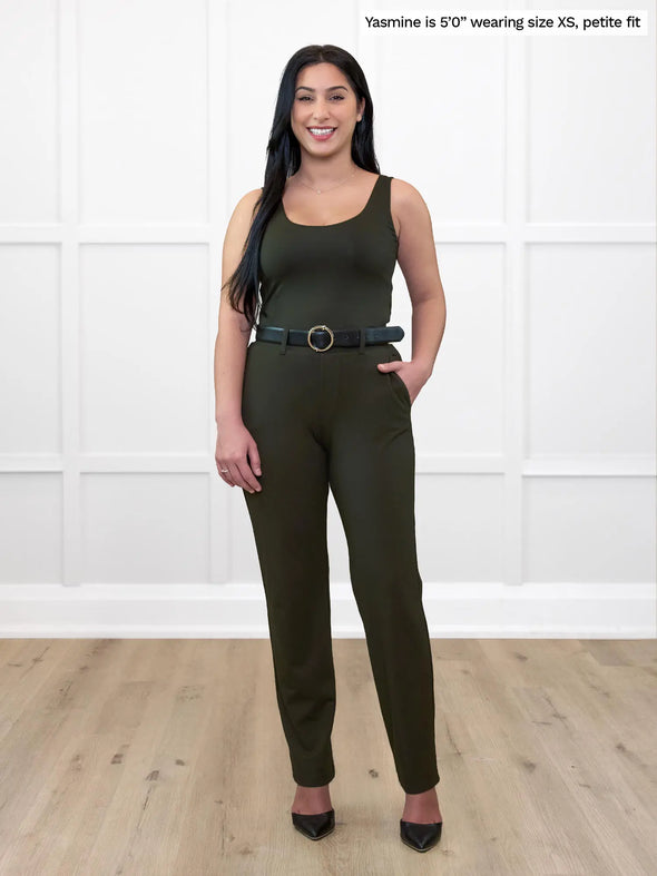 Miik model Yasmine (5'0", xsmall) smiling wearing Miik's Asia mid-rise slim pant in olive, petite fit, with a tank top in the same colour and a black belt #color_olive 