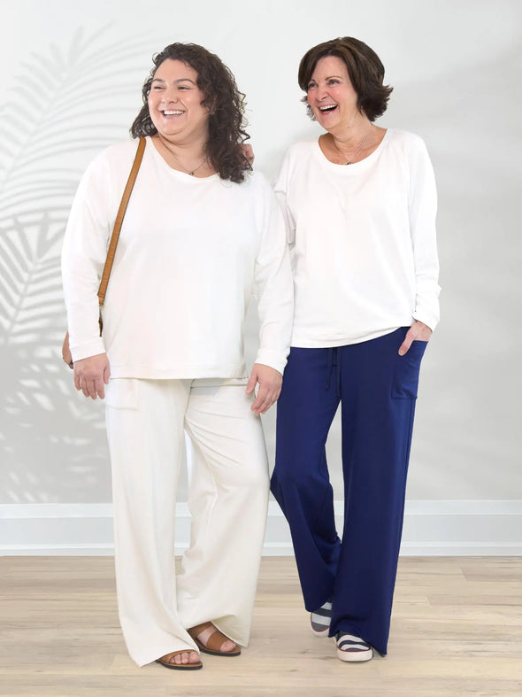 Miik model Marilyn and founder Donna standing next to each other and looking away both wearing Miik's Aurelia lightweight french terry sweatshirt in natural #color_natural