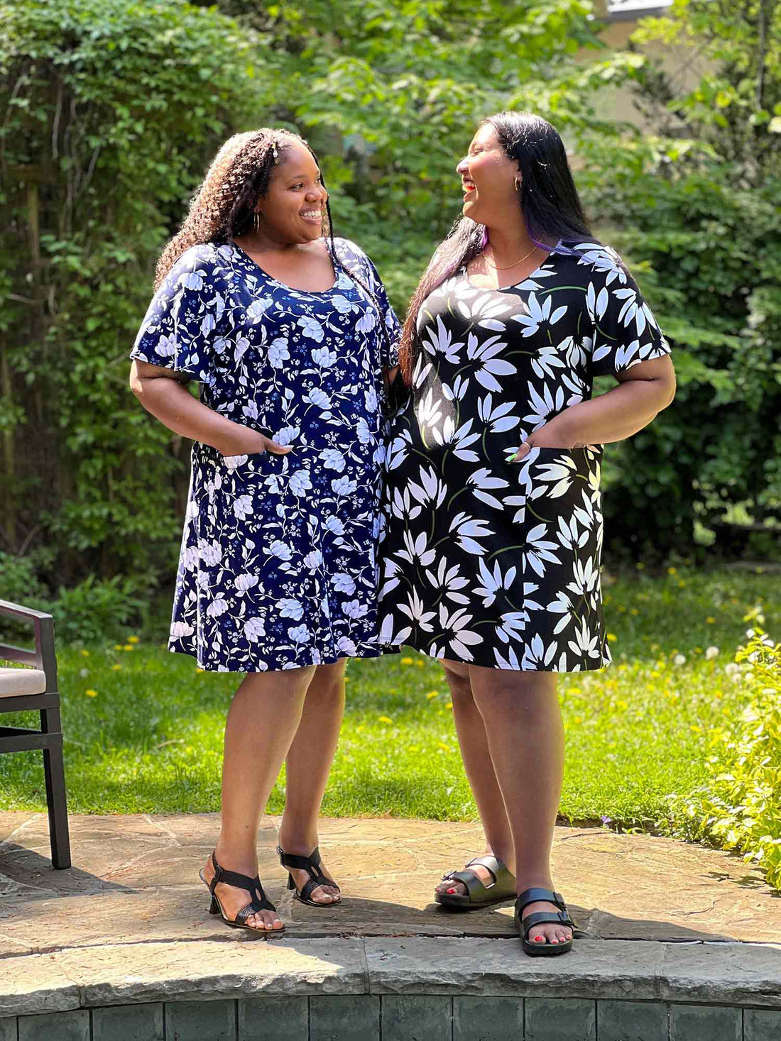 Miik models plus size Kimesha and Sureka smiling while looking at each other both wearing the same dress: Miik&