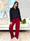 Miik model Meron (5'3", xsmall) smiling wearing Miik's Bryce plaid bamboo PJ pant in poppy buffalo plaid along with a zip up pullover in black #color_poppy-buffalo-plaid