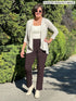 Miik founder Donna (size S, five foot 6) wearing the Christal pull-on pintuck ankle pant in chocolate brown in regular length with an off-white tank and matching cardigan. 