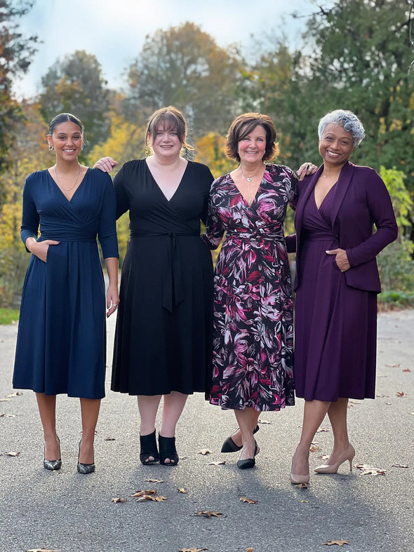 Miik model Meron, Bri, Keethai and founder Donna all wearing the new Miik dress: Claudine tie waist midi dress. Meron is wearing in navy, Bri in black, Donna in midnight floral print while Keethai is wearing in port 