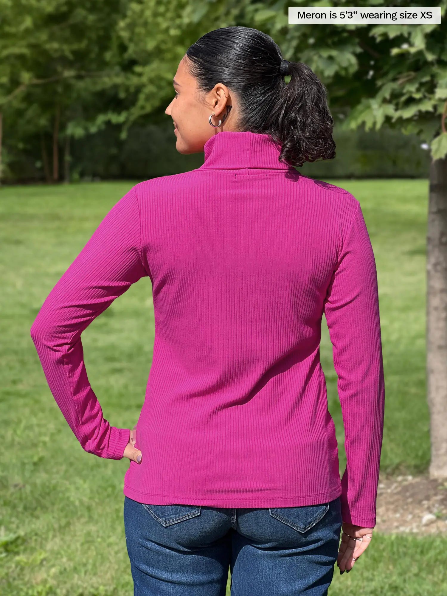 Miik model Meron (5’3”, xsmall) standing with her back towards the camera showing the back of Miik&