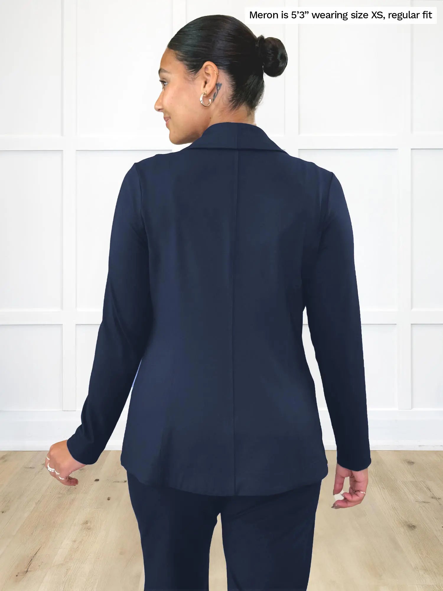 Miik model Meron (5’3”, xsmall) standing with her back towards the camera showing the back of Miik&