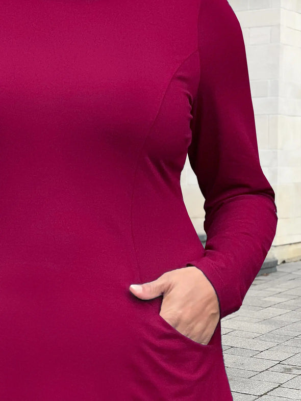 A close up shot of the side pocket of Mik's Kaito cowl neck pocket tunic in cerise #color_cerise 