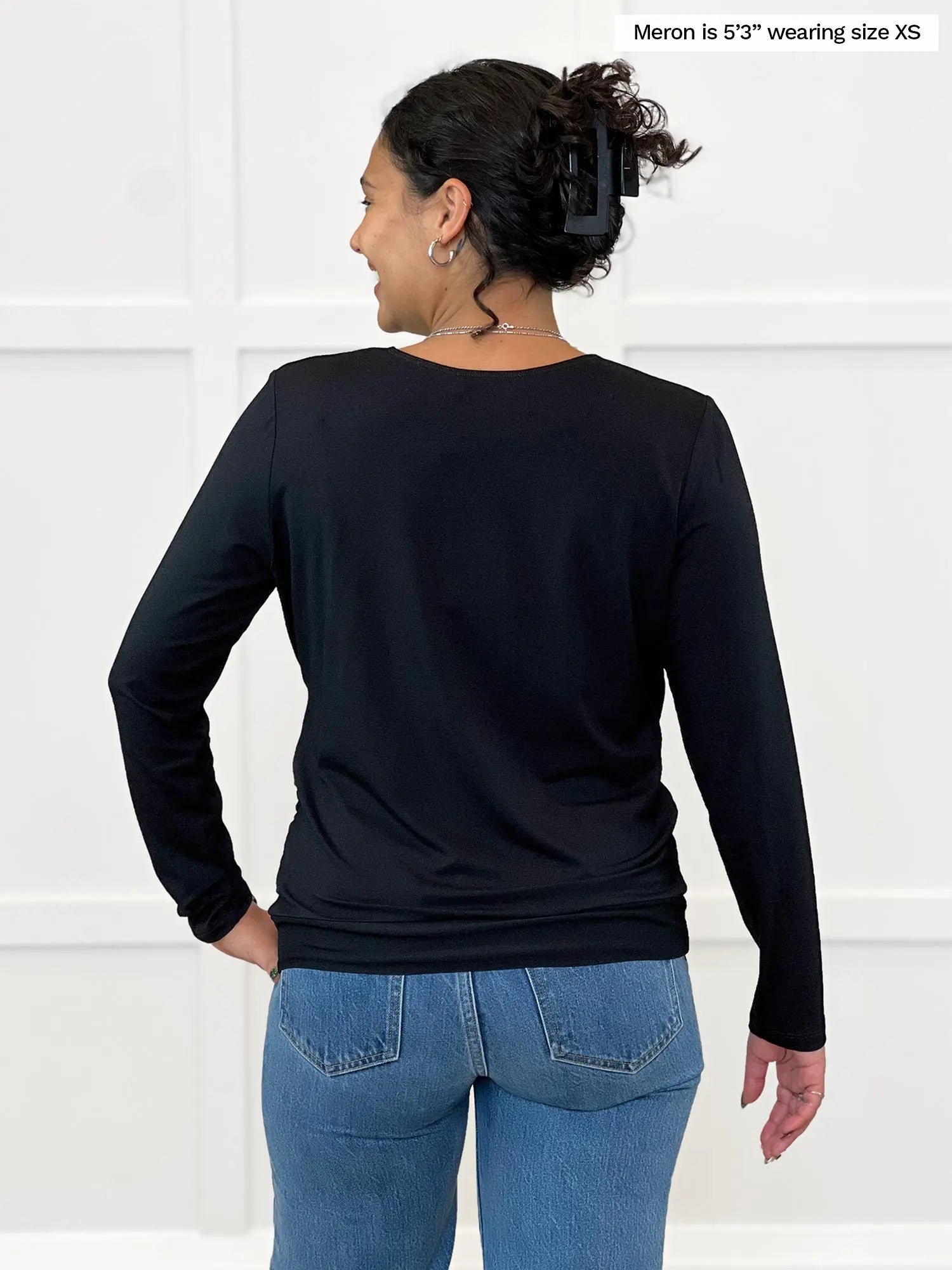 Miik model Meron (5’3”, xsmall) standing with her back towards the camera showing the back of Miik&