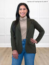 Miik model Yasmine (5'0", xsmall, petite) smiling wearing Miik's Kerry turtleneck top in mushroom melange, petite fit, with jeans and a olive blazer  #color_mushroom-melange