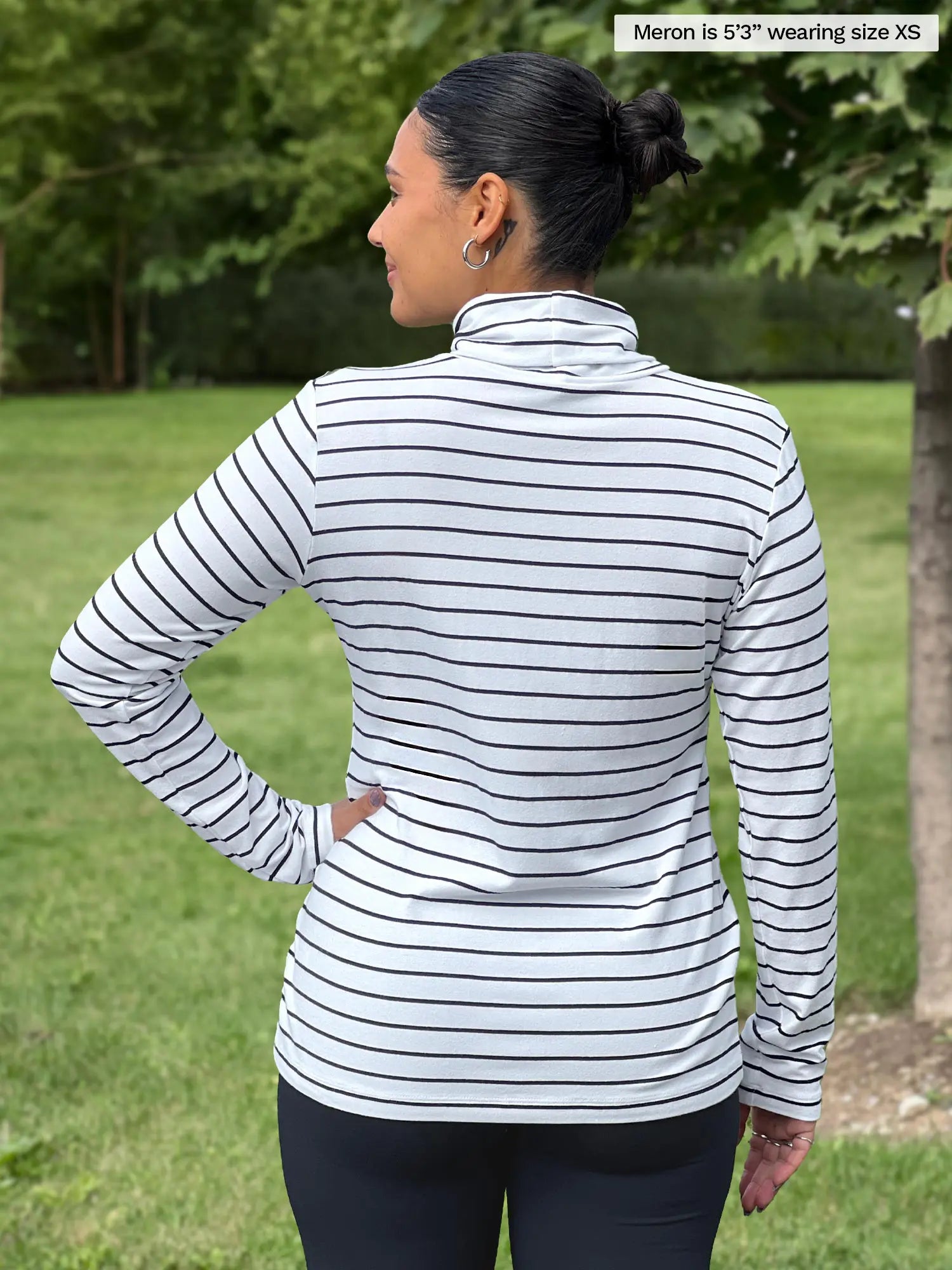 Miik model Meron (5’3”, xsmall) standing with her back towards the camera showing the back of Miik&