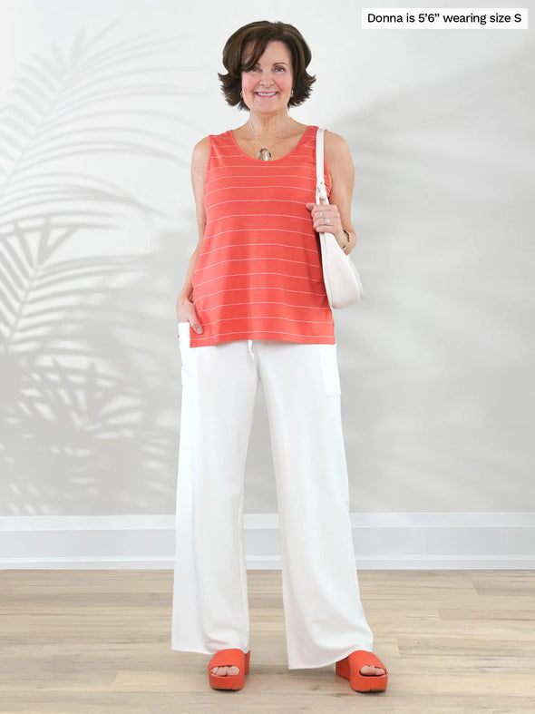 Miik founder Donna (5'6", small) smiling wearing Miik's Kimber french terry wide leg lounge pant in natural with a papaya pinstripe tank top #color_natural