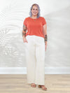 Miik model Kaitlin (5'9", xxlarge) smiling wearing Miik's Kimber french terry wide leg lounge pant in natural with a papaya melange tee #color_natural