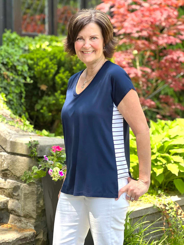 Miik founder Donna smiling wearing Miik's Kylie striped side band top in navy coastal stripe with white jeans 
#color_navy-coastal-stripe