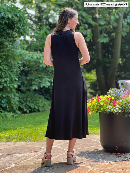 Miik model Johanna (five feet six, size xsmall) standing with her back towards the camera showing the back of Miik&