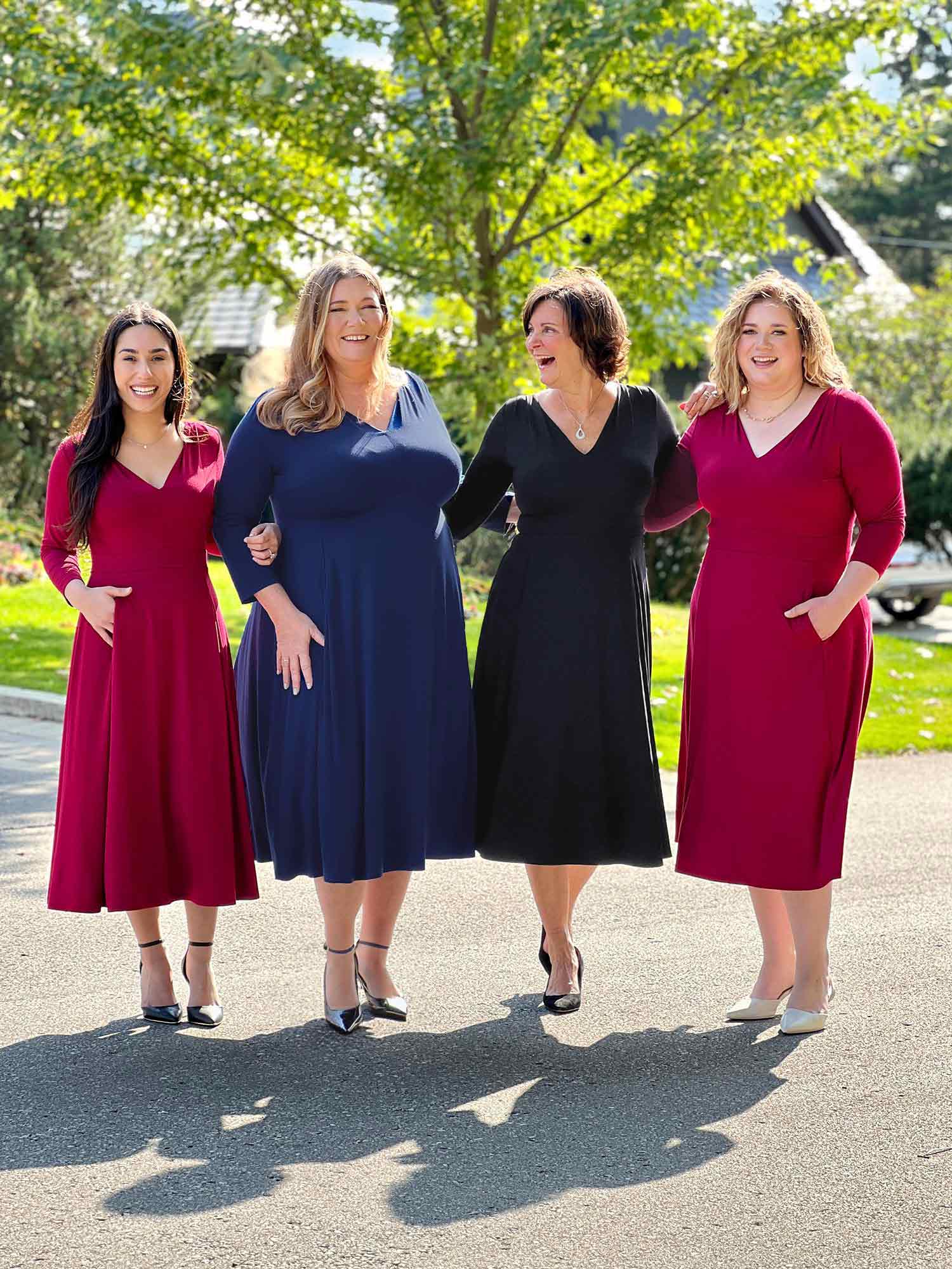 Miik models Yasmine, Kelly and Bri along with Miik founder Donna standing next to each other all wearing the same dress: Lolly midi flounce dress with pockets