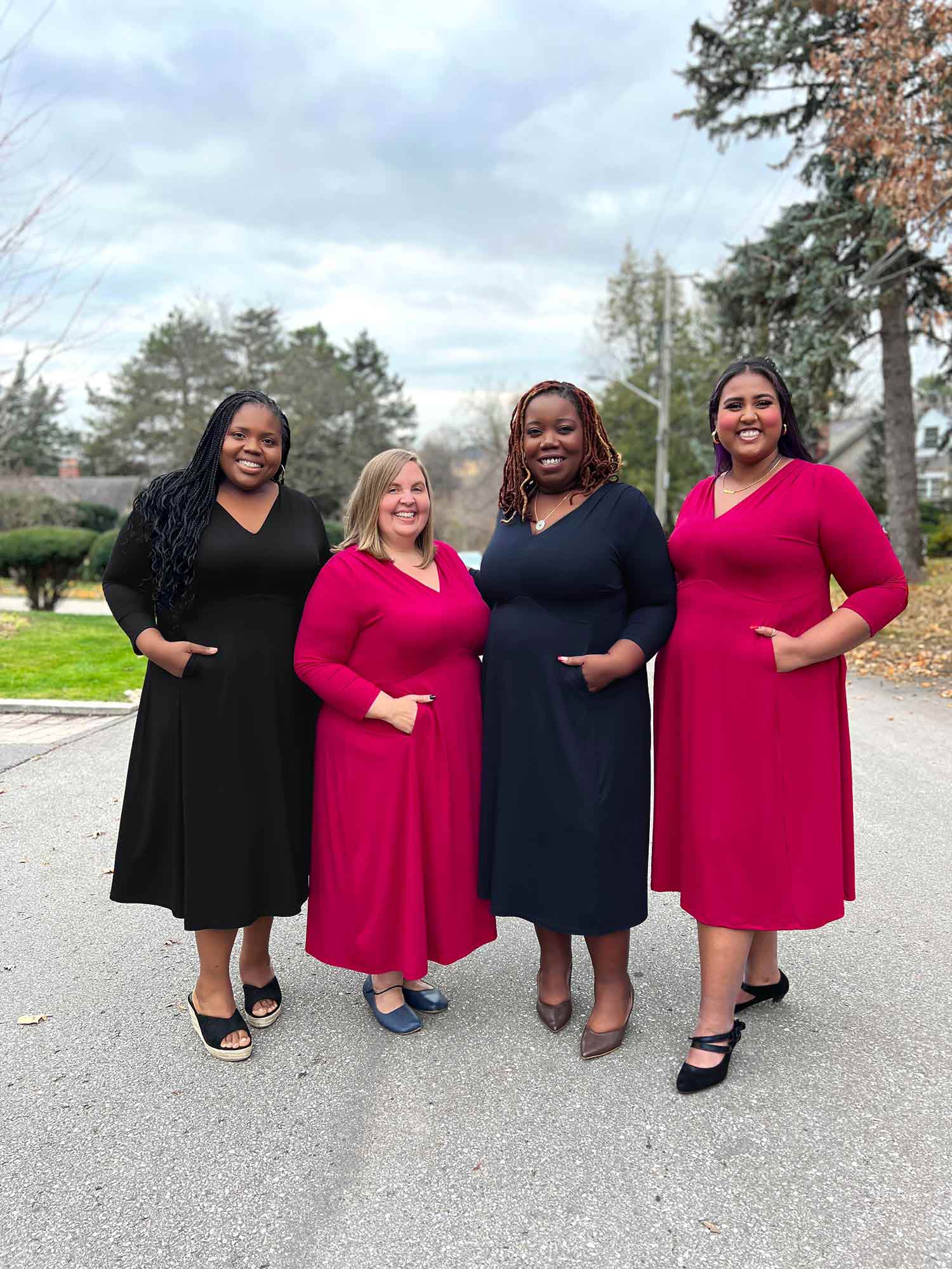 Miik models plus size Kimesha, Jennifer, Erica and Sureka standing next to each other smiling all wearing Miik&