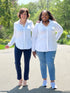 Miik founder Donna and model Kimesha each wearing the Lucia collared shirt in white, with navy dress pants and jeans, respectively.
