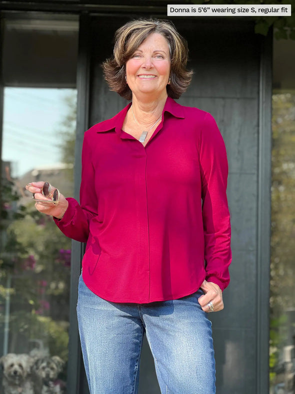 Miik founder Donna (5'6", small) smiling wearing Miik's Lucia collared shirt in cerise, regular fit, with jeans 
#color_cerise 