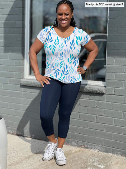 Woman smiling and standing in front of a brick wall wearing Miik&