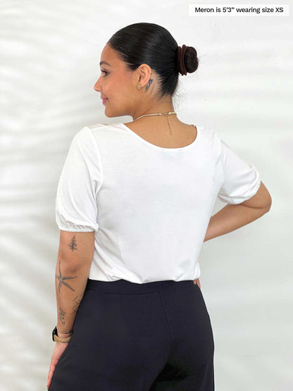 Miik model Meron (5’3”, xsmall) standing with her back towards the camera showing the back of Miik&