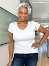 Miik model Keethai (5'5", medium) smiling wearing Miik's Marianna reversible classic tee in white with jeans 
#color_white 