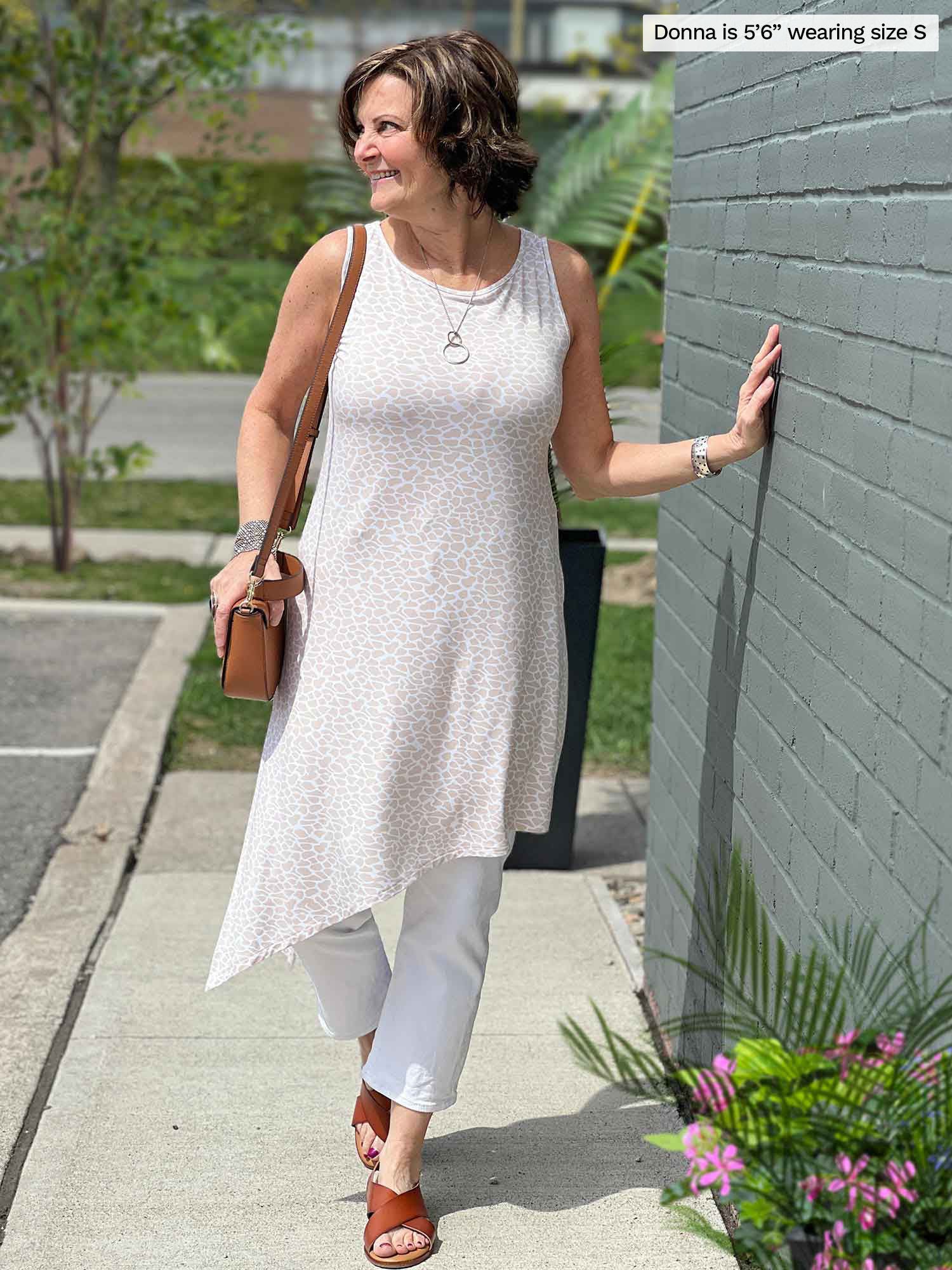 Miik founder Donna (five feet six, small) standing in a sidewalk looking away wearing a white jeans with Miik&