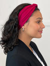 Miik model Meron smiling wearing Miik's Matana twist knot headband  in cerise #color_cerise 