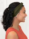 Miik model Meron smiling wearing Miik's Matana twist knot headband in olive #color_olive