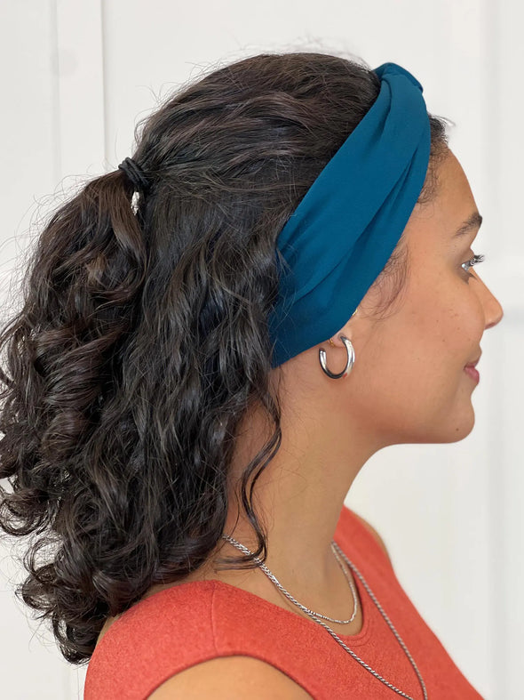 Miik model Meron wearing Miik's Matana twist knot headband in teal #color_teal