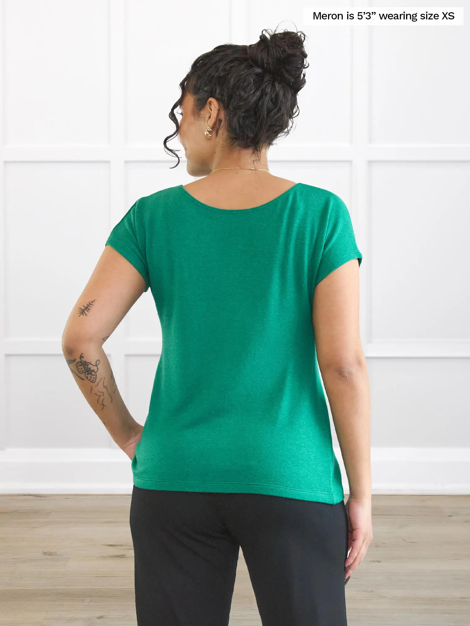 Miik model Meron (5’3”, xsmall) standing with her back towards the camera showing the back of Miik&