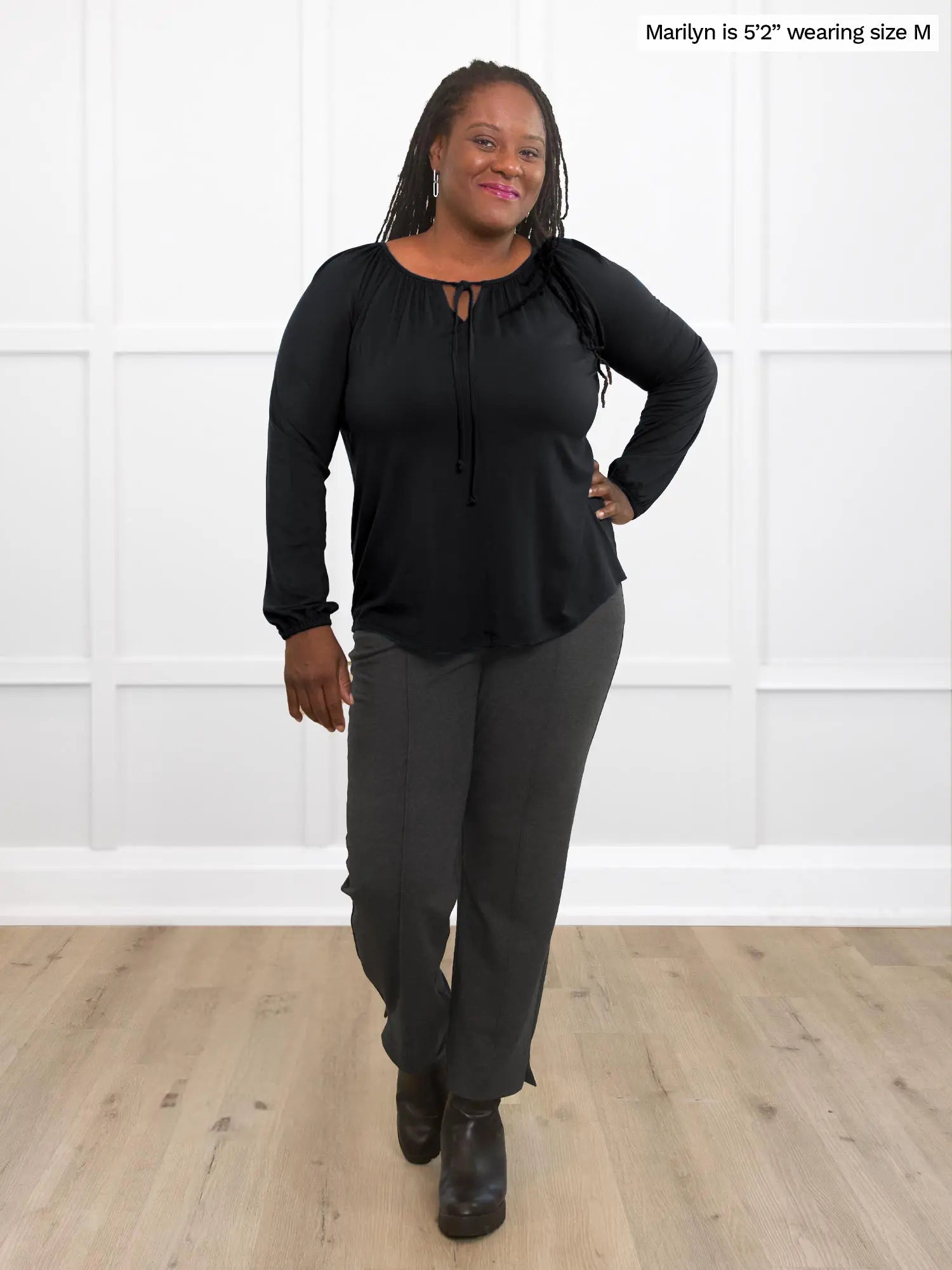 Miik model Marilyn (size M) wearing the Mitchel long sleeve boho blouse in black with charcoal pants. 