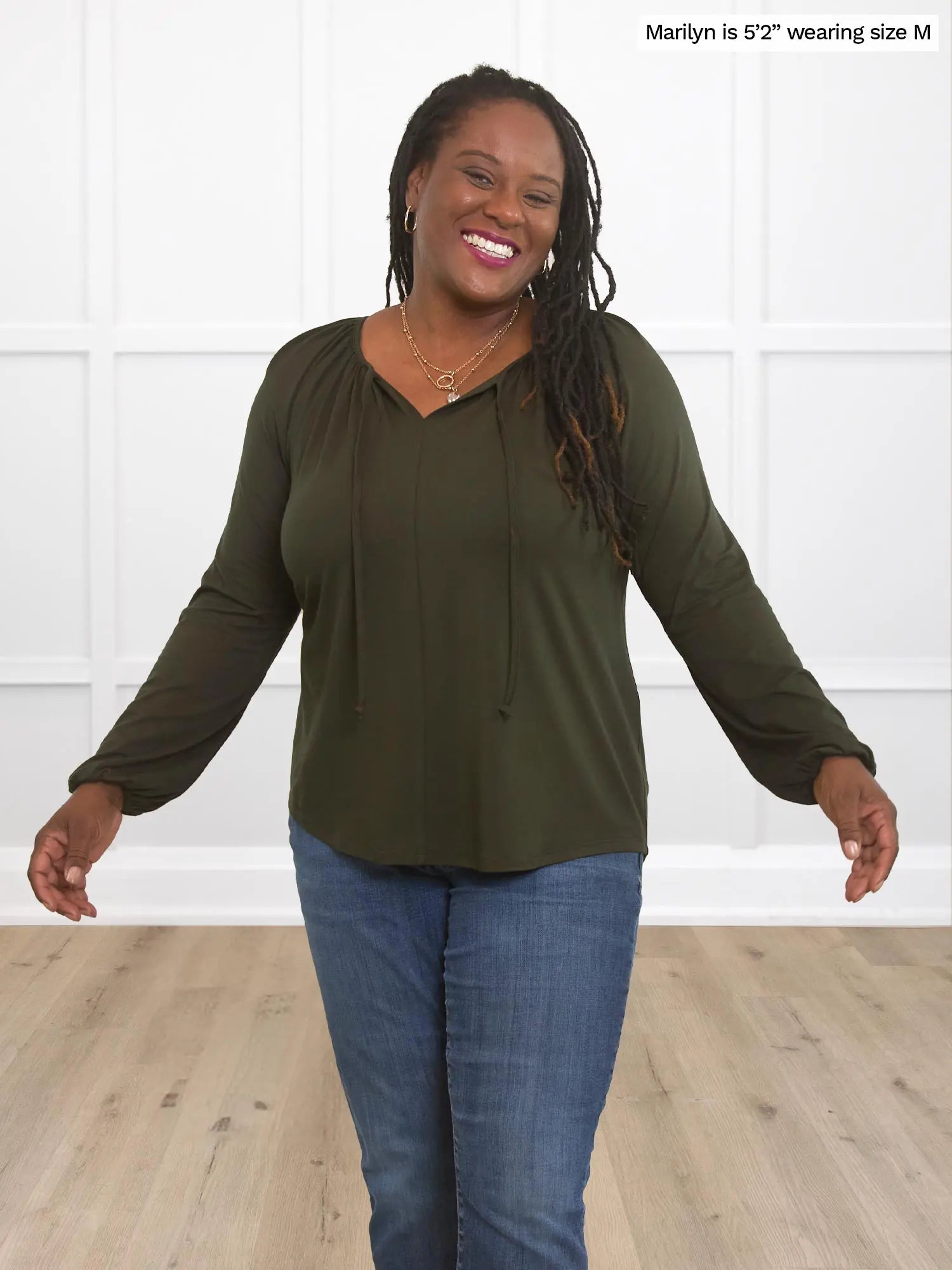 Miik model Marilyn (size M) wearing the Mitchel gathered sleeve peasant blouse in olive green with blue jeans. 