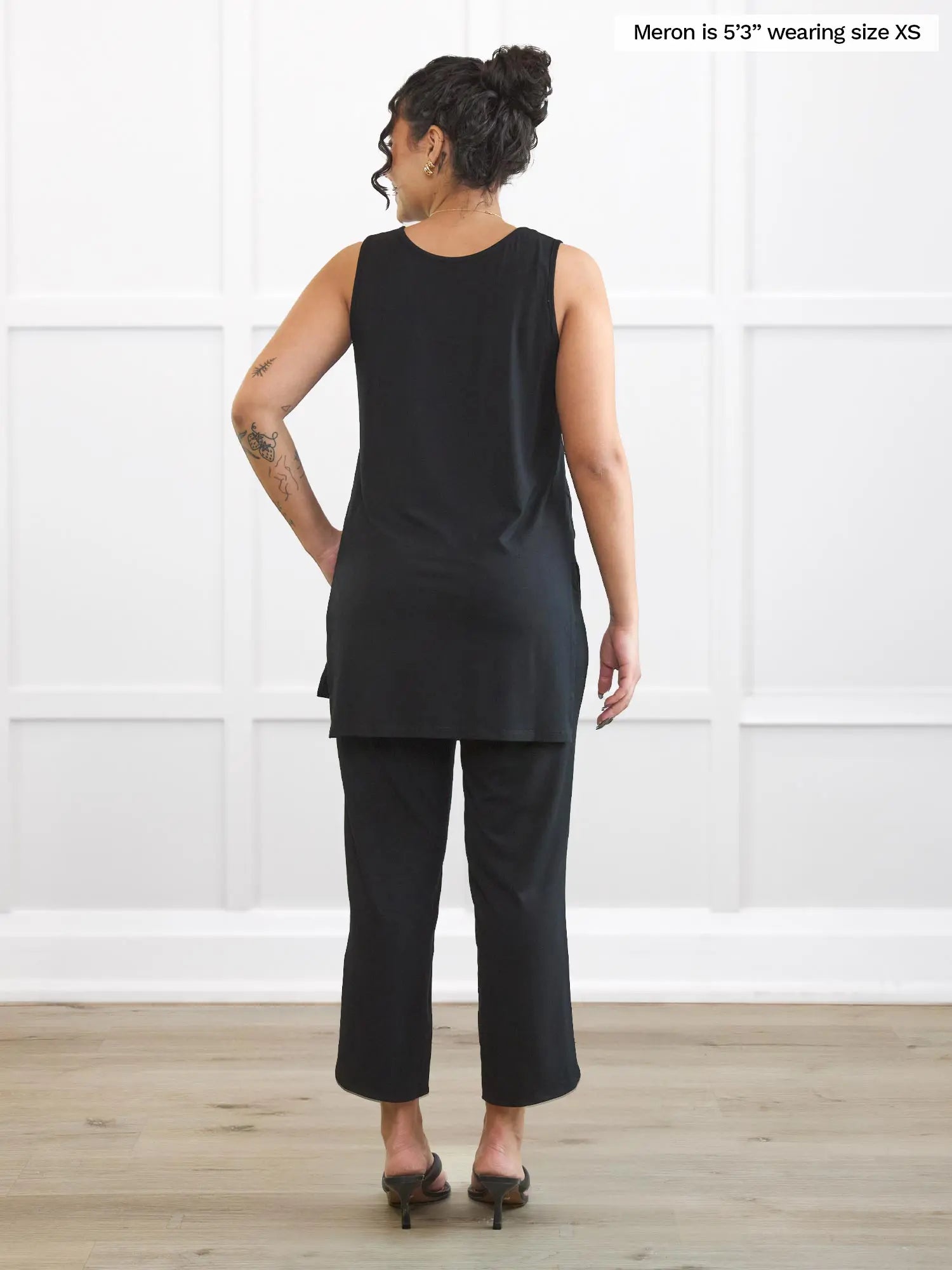 Miik model Meron (5’3”, xsmall) standing with her back towards the camera showing the back of Miik&