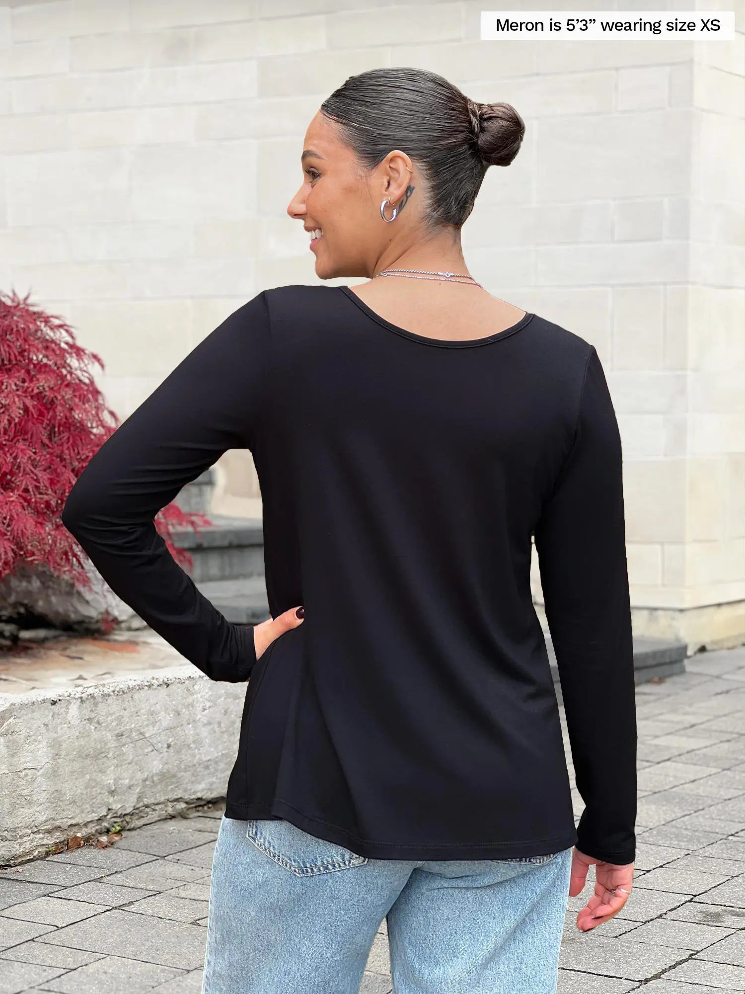 Miik model Meron (5’3”, xsmall) standing with her back towards the camera showing the back of Miik&