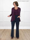 Miik founder Donna (5'6", small) smiling and looking away wearing Miik's Reed high waisted pant with pockets in navy, regular fit, with a tank top in port and a waterfall cardigan in the same colour 
#color_navy