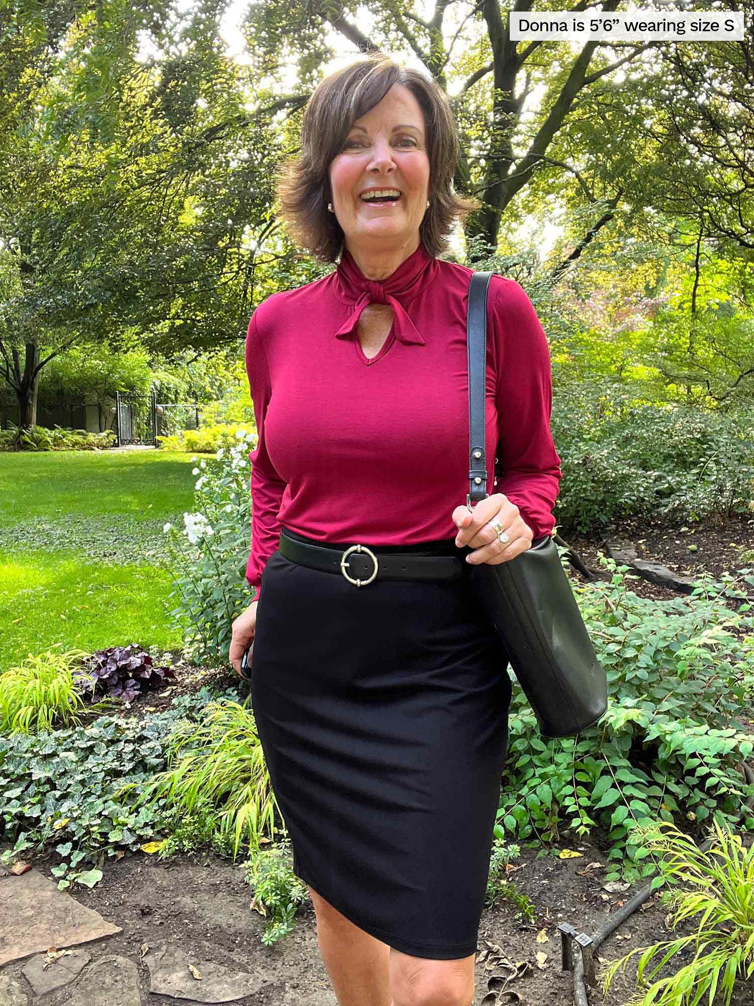 Miik founder Donna (five feet six, small) standing in a backyard smiling wearing Miik&