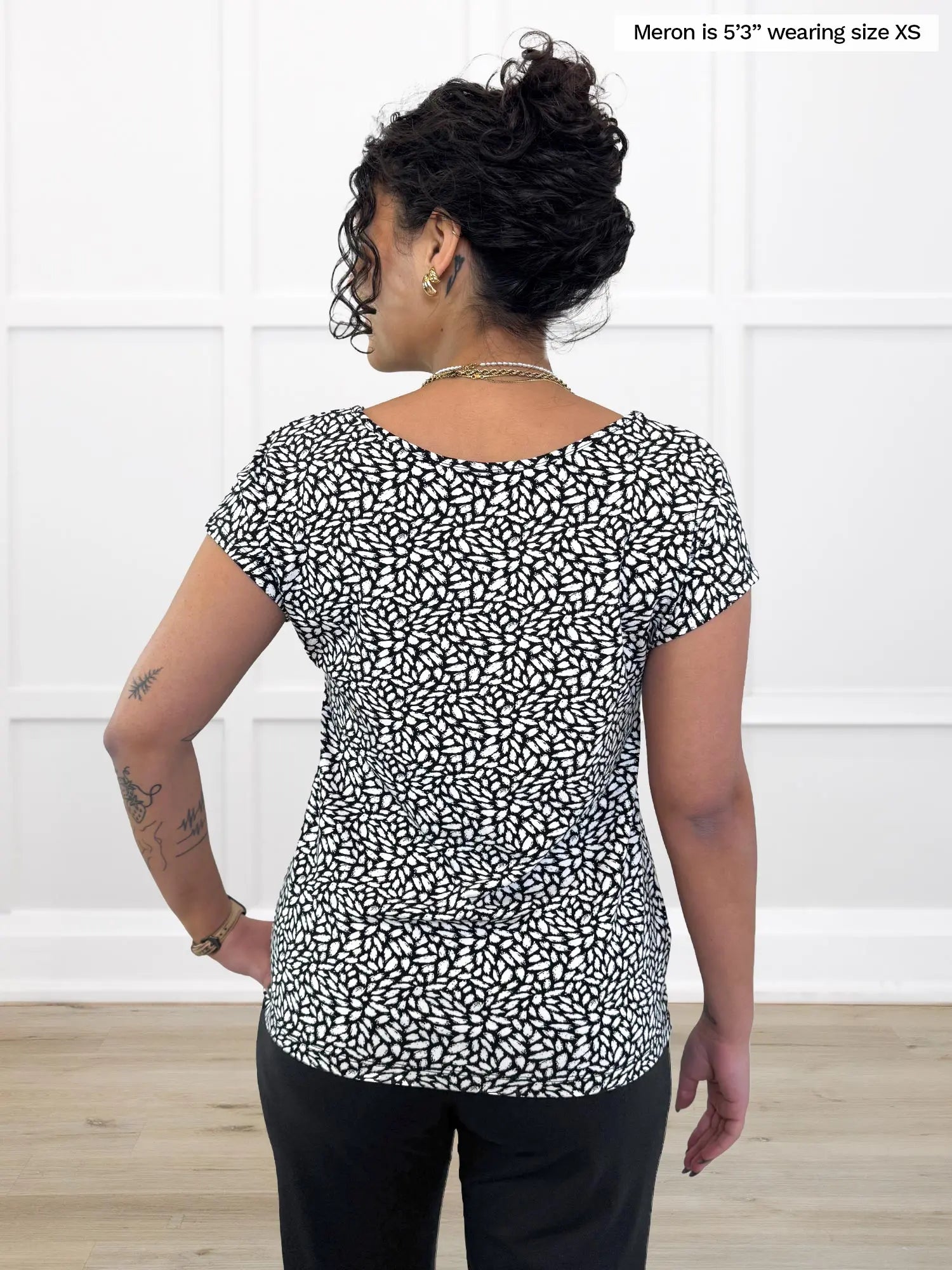 Miik model Meron (5’3”, xsmall) standing with her back towards the camera showing the back of Miik&