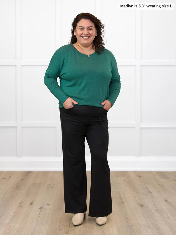 Miik model Marilyn (size L, 5'3") wearing the Rosalie dolman sweater in evergreen with black dress pants. #color_evergreen