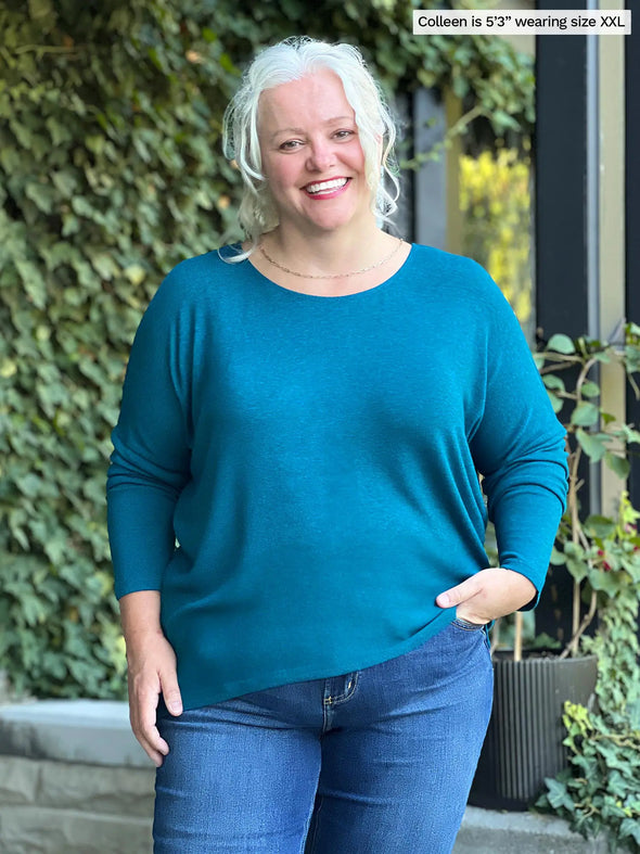 Miik model Colleen (size XXL, 5'3") wearing the Rosalie dolman sweater in moroccan blue with jeans. #color_moroccan-blue