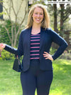 Miik model Andrea (5'10", large, tall) smiling wearing an all navy suit: Emily blazer + Christal pant with Miik's Shandra reversible tank top - beach house stripe