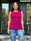 Miik model Meron (5'3", xsmall) wearing Miik's Shandra reversible neckline tank top in cerise with a ripped jeans 
#color_cerise 