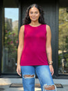 Miik model Meron (5'3", xsmall) wearing Miik's Shandra reversible neckline tank top in cerise with ripped jeans 