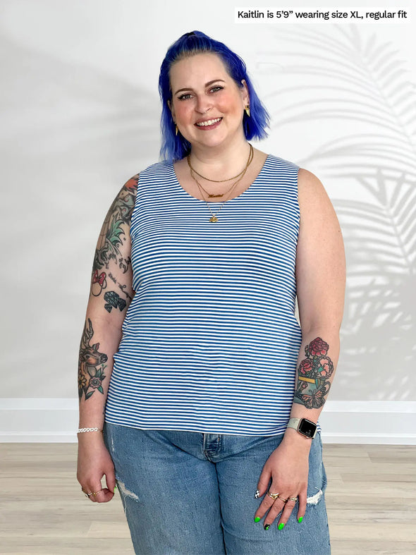 Miik model Kaitlin (5'9", xlarge) smiling wearing Miik's Shandra reversible tank top in cobalt mini stripe with jeans
#color_cobalt-mini-stripe