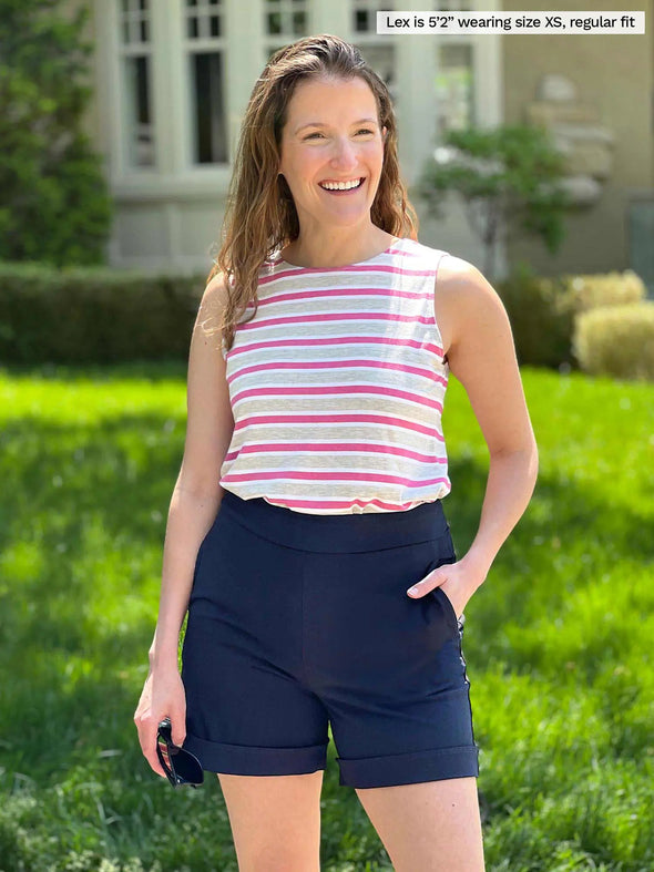 Miik model Lex (5'2", xsmall) smiling wearing Miik's Shandra reversible tank top in grey garden stripe with a navy shorts 
#color_grey-garden-stripe 