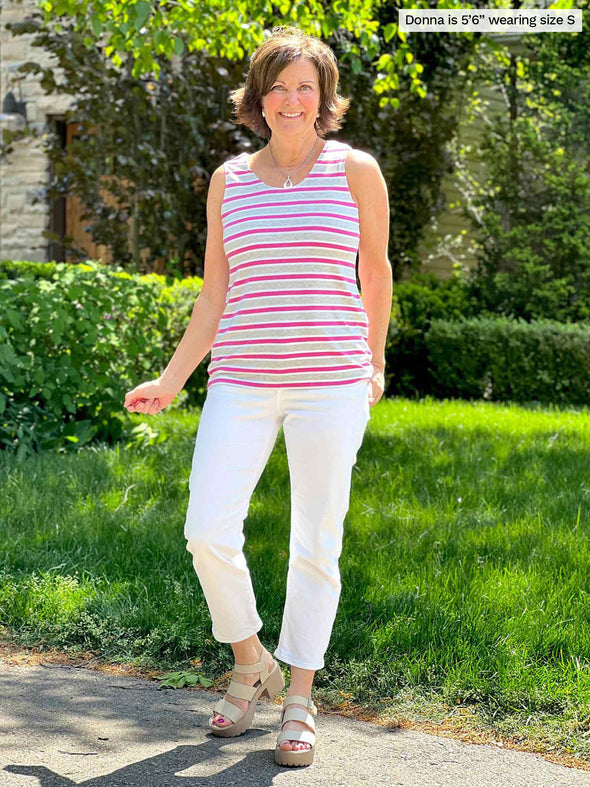 Miik foundere Donna (5'6, small) smiling wearing a white capri jeans with Miik's Shandra reversible tank top in grey garden stripe