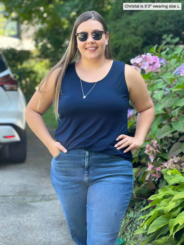 Miik model Christal (size L, five foot three) wearing Shandra reversible tank top in navy blue, with the scoop neck in front.
